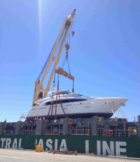 Luxury yacht being crane lifted in cradle