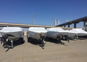 Five trailer boats wrapped ready for shipping
