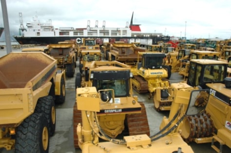 Caterpillar and Komatsu mining machinery being transported on a RORO vessel
