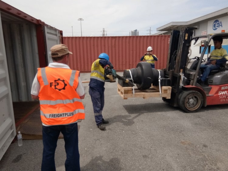 Supervising mining equipment being loaded into shipping container