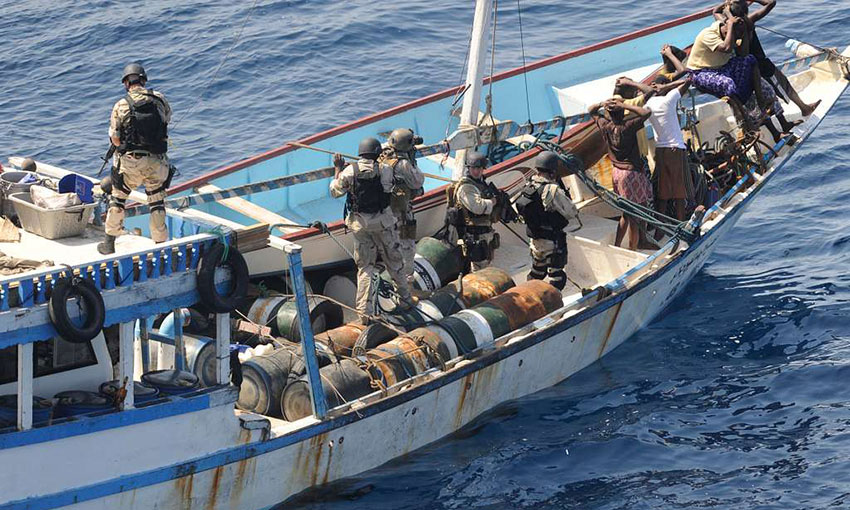 US military personnel from USS Chosin boarding a suspected pirate dhow in the Gulf of Aden in 2009.